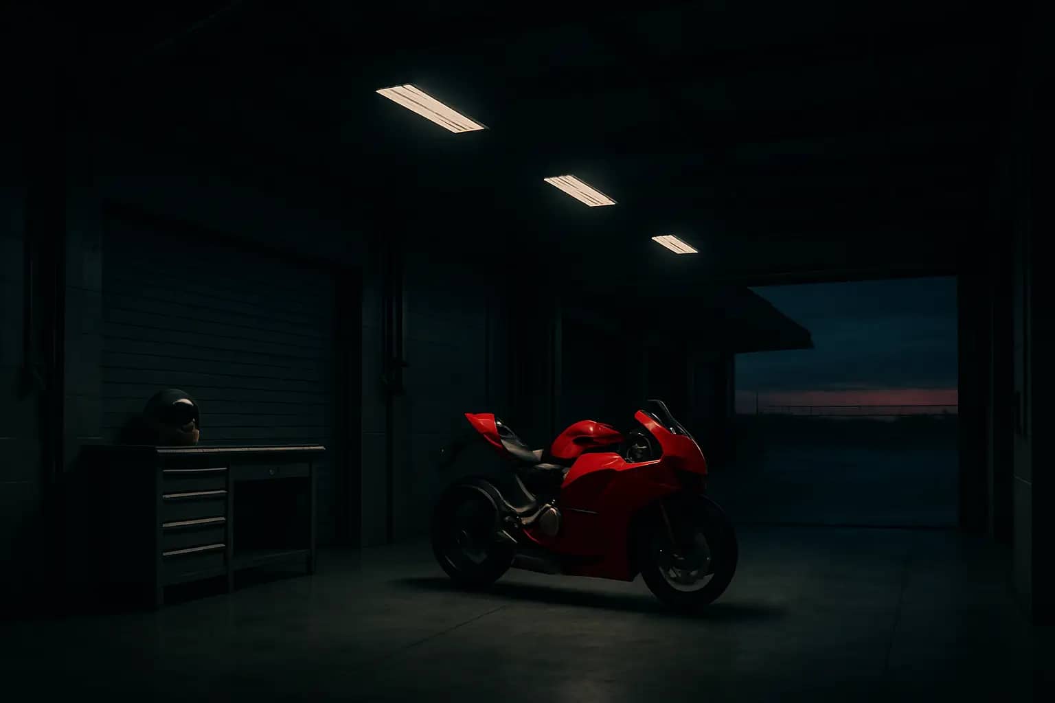 A MotoGP factory garage at dusk with an empty pit wall and a Ducati racing machine in the background